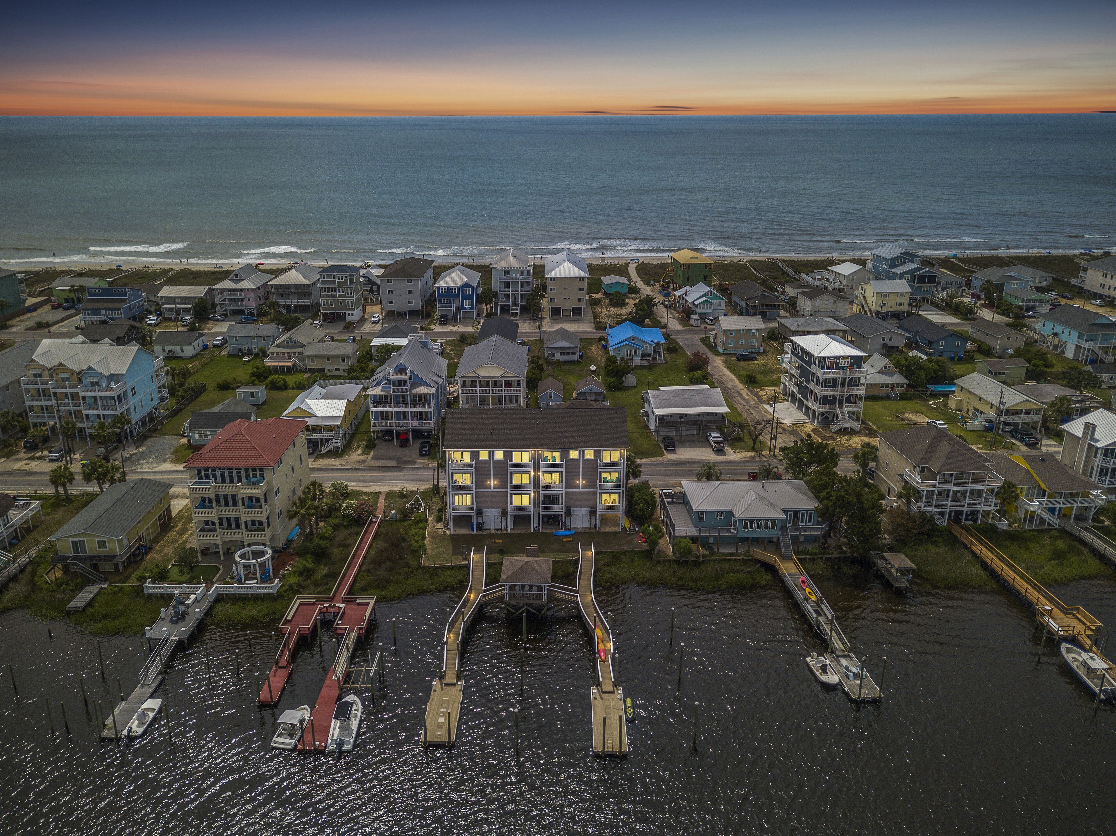 A coastal residential area with houses, a dock, and boats.