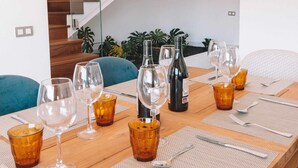 A dining table set with glasses and bottles, a staircase, and a view of the outdoors. - Villa Privada de Lujo con Piscina, Villa Sabi Sabi (Corralejo Playa)