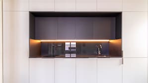 Een moderne keuken met een inbouwoven, een spoelbak en een aanrecht.