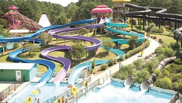 A water park with multiple slides and a pool area.