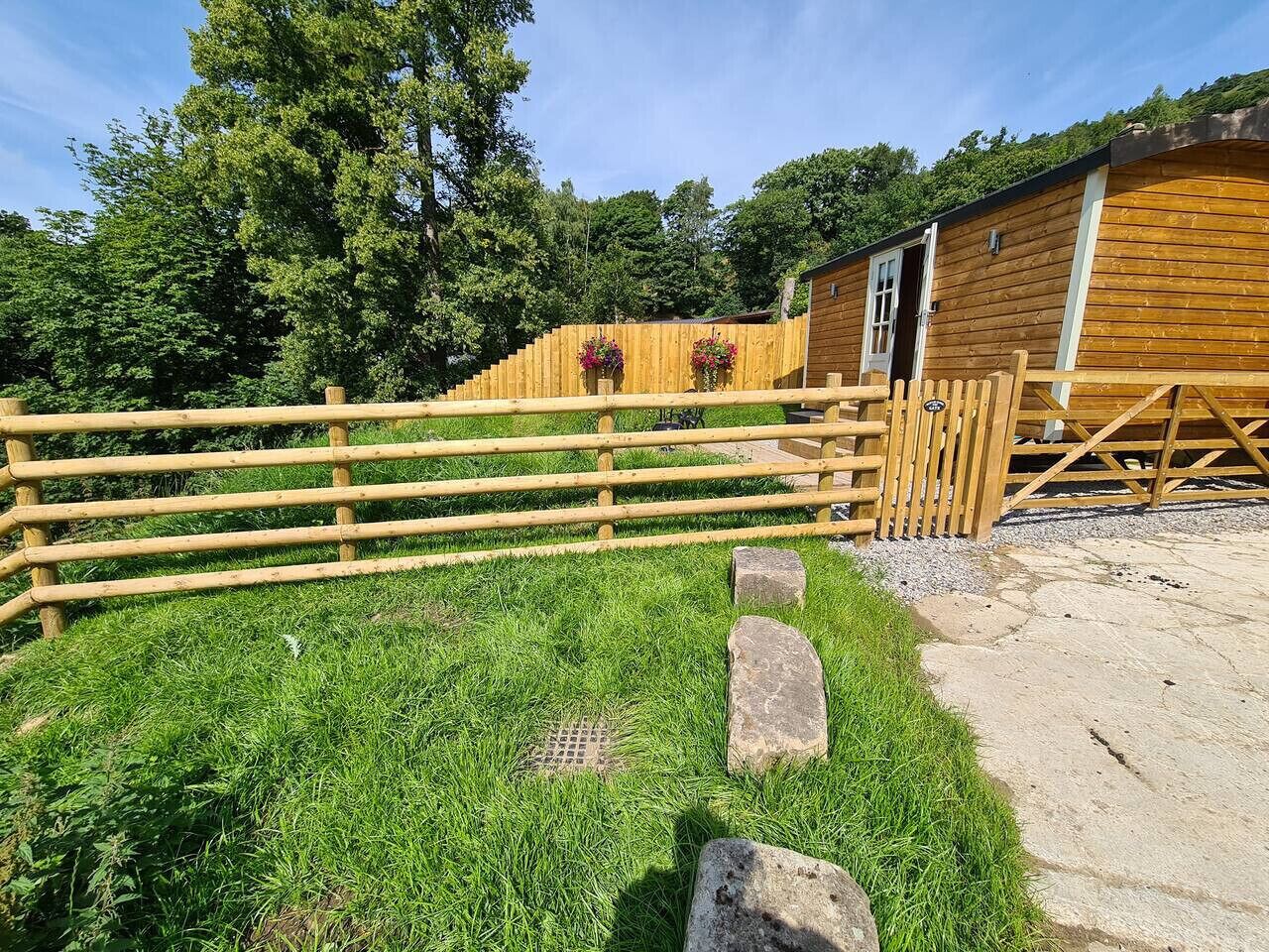 A wooden fence, a grassy area, and a building with a door.