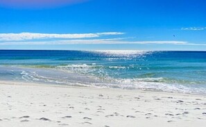 A beach with clear skies and calm waves.