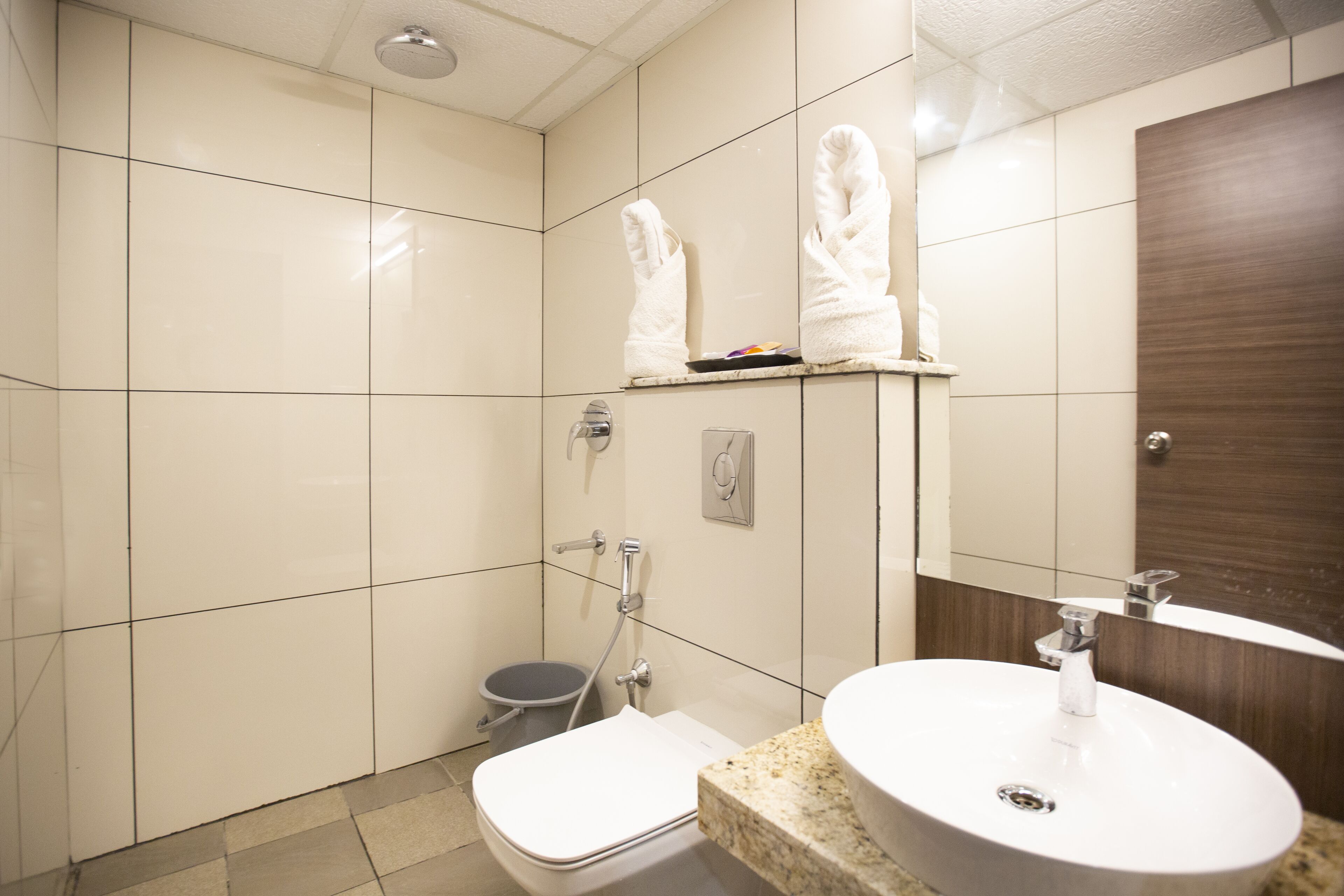 A bathroom with a toilet, sink, and shower.