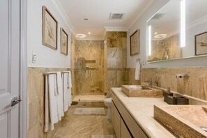 A modern bathroom with a walk-in shower, a large mirror, and a vanity with a sink. - Breathless 4You, Oceanfront Penthouse (Cap Cana)