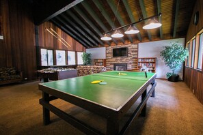 Relax in this inviting space with a pool table, fireplace, and comfortable seating area.
