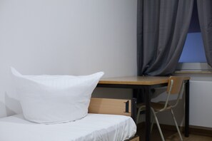 Premium bedding, desk, laptop workspace, blackout curtains