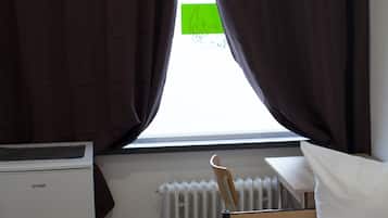 Premium bedding, desk, laptop workspace, blackout drapes