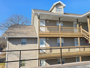 A two-story building with a balcony on the second floor.