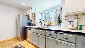 Enjoy a peaceful kitchen with a double sink, modern faucet, and a coffee maker.
