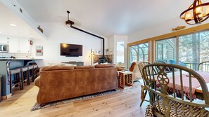 Relax in this spacious living area with a plush sofa, flat-screen TV, and dining table.