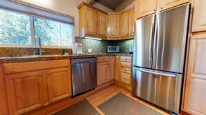 Enjoy cooking in this well-equipped kitchen with a dishwasher, microwave, and refrigerator.