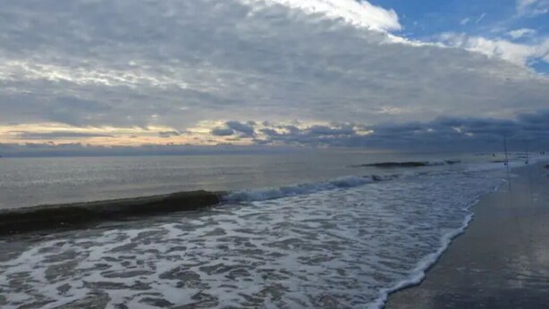 A beach with waves and a cloudy sky. - Tybee Beach views, just steps to the ocean (Tybee Island)