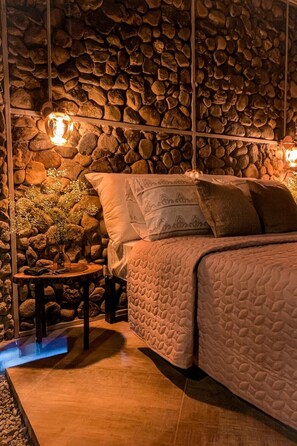 Relax in this serene bedroom with a plush bed, bedside tables, and elegant lamps.