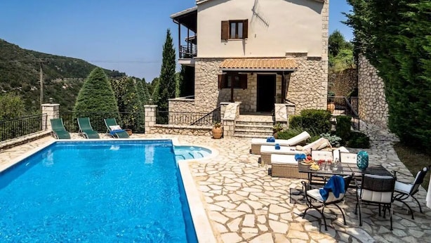 A two-story villa with a swimming pool, stone exterior, and outdoor seating area. - Luxurious Pool Villa Kavalos (6-11people) (Kavallos)