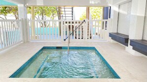 A swimming pool with a white fence and a ladder.