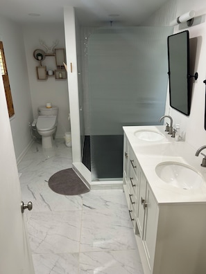 Shower, hair dryer, towels, toilet paper
