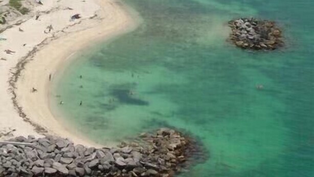 A beach with clear turquoise waters, a sandy shore, and rocky outcrops. - Roosters Perch at Truman Annex- LOW SUMMER RATES!!! (Key West)