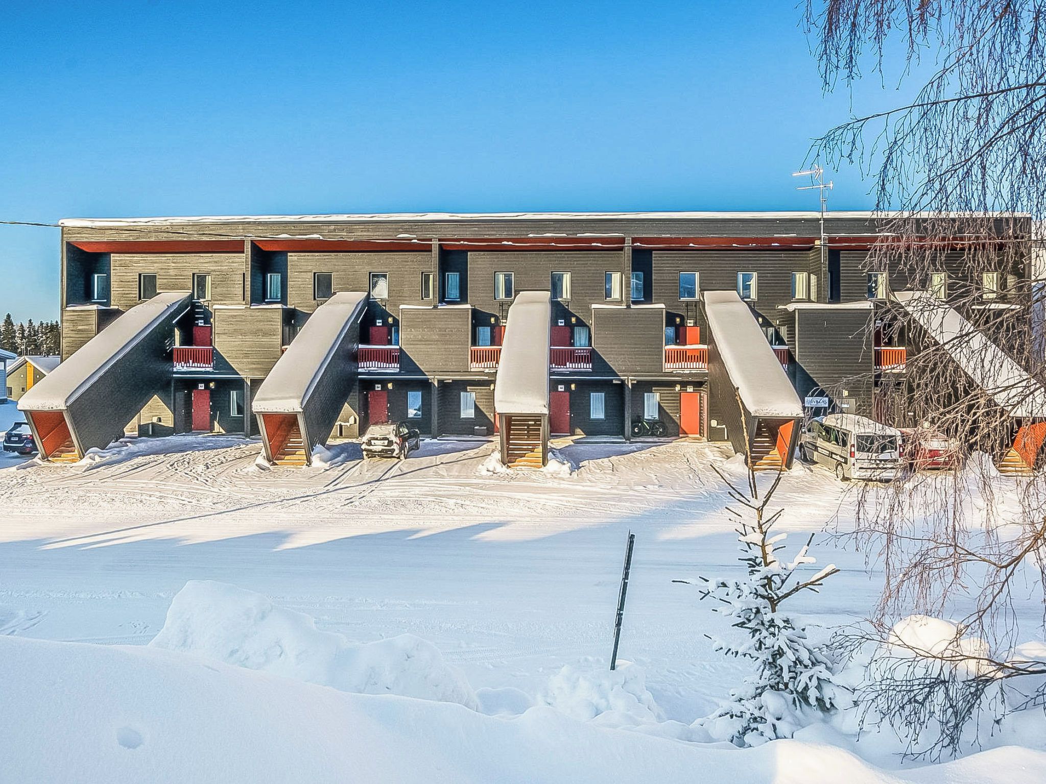 En byggnad med flera våningar och en unik arkitektonisk design, med utvändiga trappor och balkonger.