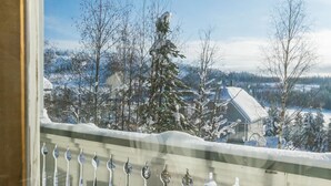 A snowy landscape with bare trees and a house in the background. - Gasthalla b paritalo by Interhome (Hyrynsalmi)