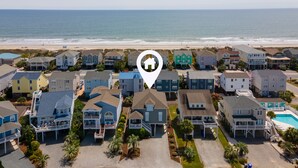 A coastal residential area with houses, a beach, and a swimming pool. - 4BR beach getaway steps away from the beach with community pool (Ocean Isle Beach)