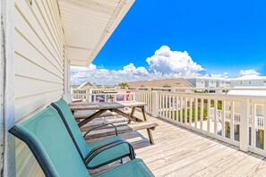 Guests can enjoy the view from this outdoor seating area with chairs and a table.