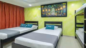 A hotel room with two beds, each with a pillow labeled "ayenda HOTEL."