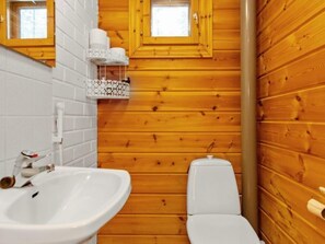 A compact bathroom with a sink, toilet, and towel rack, designed for efficient use.