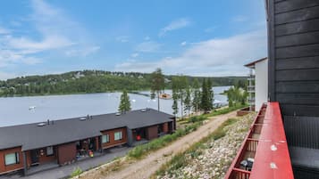 A lakeside hotel with a view of the lake and forested hills.