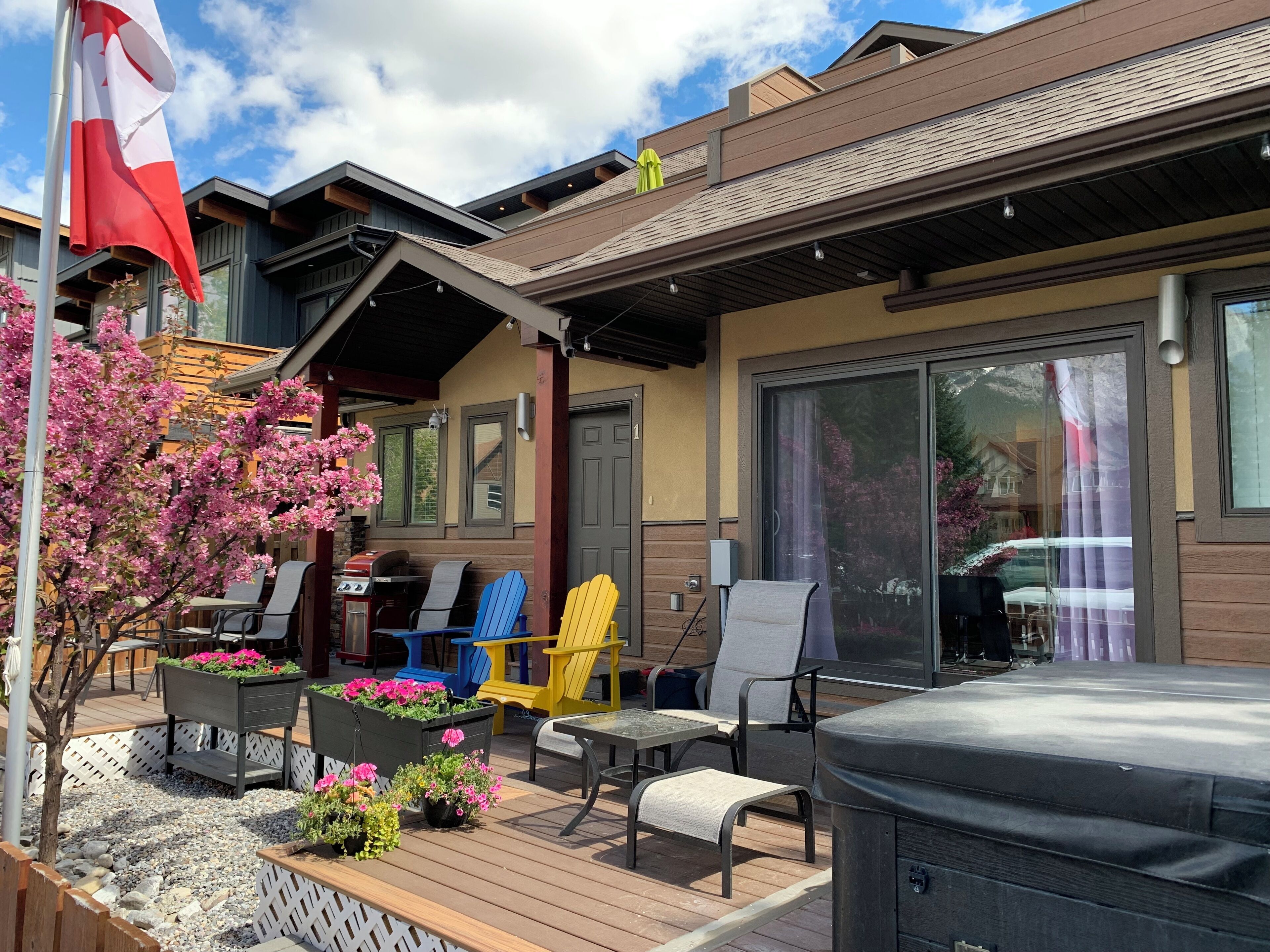 A patio area with outdoor seating, a grill, and a flag.
