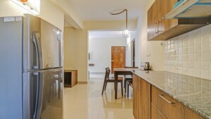 Deluxe Double Room, Balcony | Private kitchen | Coffee/tea maker, mini-fridge, electric kettle - Treebo Aquamarine Arpora With Pool (Arpora)
