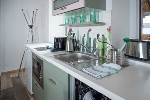 Een moderne keuken met een roestvrijstalen spoelbak, een koffiezetapparaat en een broodrooster.