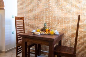 Enjoy a casual breakfast at this inviting dining area with a table set for two.