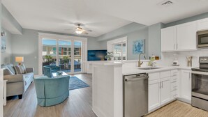 A modern kitchen with white cabinets, a dishwasher, and a microwave.