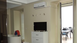 A bedroom with a bed, a TV on a dresser, a bathroom with a shower, and a balcony with outdoor furniture. - Chicca suite with terrace in the heart of the historic center of Catania (catania)