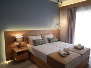 Relax in a serene space with a large bed, wooden headboard, and a stylish nightstand.