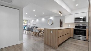A modern kitchen with a central island, built-in oven, and microwave. - 2br Luxury Ocean Reserve With Park Views! 2 Bedroom Condo by RedAwning (Sunny Isles Beach)
