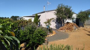 A building with a corrugated metal exterior, a chimney, and a satellite dish. - Moonlight Studio- Nannup's favourite accommodation.  (Nannup)