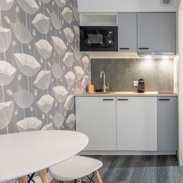 Mini-fridge, stovetop, coffee/tea maker, cookware/dishes/utensils