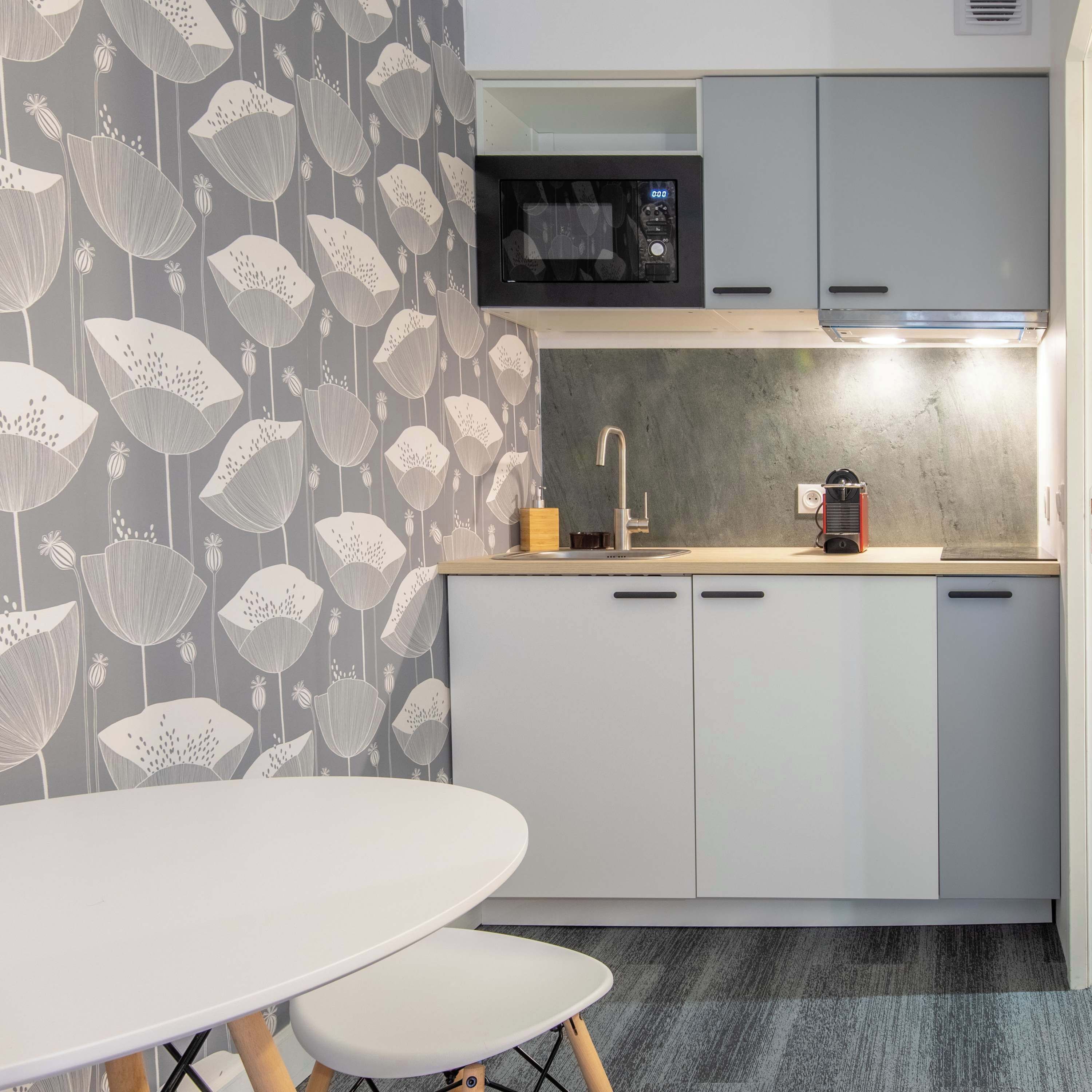 Frigorífico pequeño, placa de cocina y cafetera o tetera