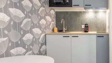 Mini-fridge, stovetop, coffee/tea maker, cookware/dishes/utensils