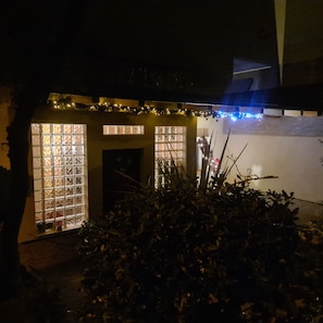 Stunning building with a unique window design, adorned with string lights.