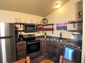 Enjoy cooking in this well-equipped kitchen with a refrigerator, microwave, double oven, and dishwasher.