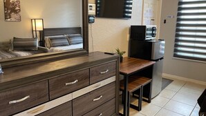 A modern bathroom with a large mirror, dark wooden vanity, and a sink. - Private Room In Regal Palms Resort, Davenport FL, Sleeps 2 (Davenport)