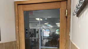 A wooden door with a glass panel leading to a sauna room. - Private Room In Regal Palms Resort, Davenport FL, Sleeps 2 (Davenport)