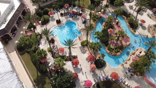 An aerial view of a resort with multiple swimming pools, palm trees, and sun loungers. - Private Room In Regal Palms Resort, Davenport FL, Sleeps 2 (Davenport)