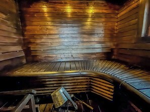 Un sauna avec des bancs en bois disposés en forme de demi-cercle.