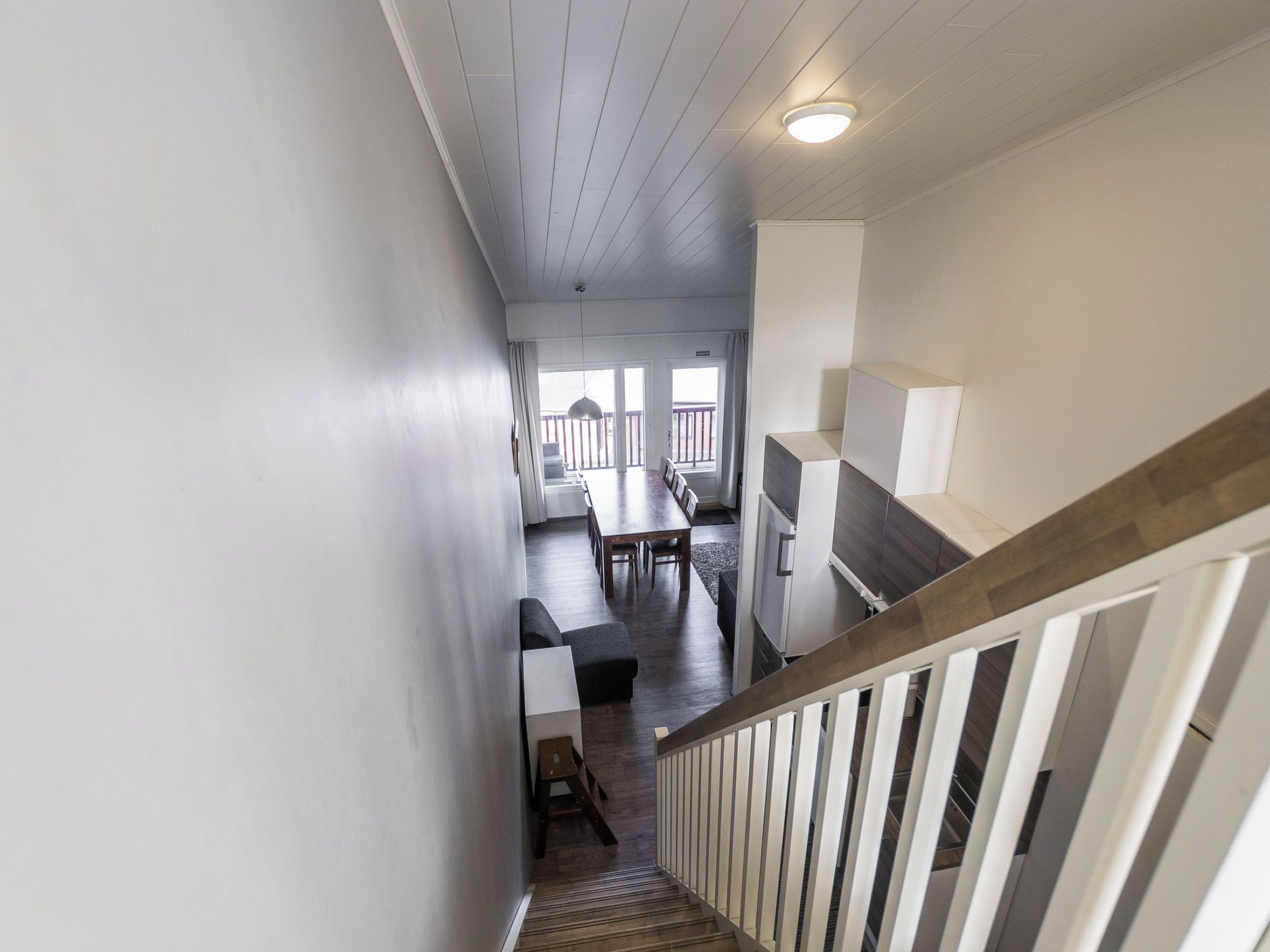 A staircase leading to a dining area with a view of the outdoors.