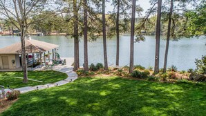 A lakeside property with a dock, a covered seating area, and a well-maintained lawn. - GREAT for FAMILIES, beautiful waterfront, kayaks, firepit, pool table, & more! (Henrico)