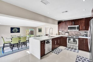 Enjoy cooking in this well-equipped kitchen with a central island, sink, and oven.