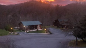 A lodge with a covered patio and a view of a forested mountain range. - LITTLE CUBBIE Location! Views! Pool!! (Sevierville)